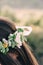 Woman in white dress standing in field wearing flower crown. Young forest inspired bride, bohemian girl vertical