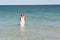 Woman in White Dress swimming in ocean