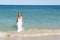 Woman in White Dress swimming in ocean
