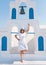 Woman in white enjoying the sun at Santorini architecture