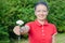 Woman with white flower and flag at peaceful protest in Belarus