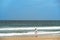 Woman in white jacket relaxing on the beach