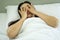 Woman on white pillow and bed sheet in bedroom relaxing on holiday stay home