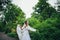 Woman in white poses in the garden