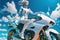 woman in white sitting on her motorcycle, Futuristic scene. Ai generative