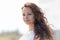 Woman in white sleeveless dress looks at camera