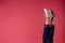 woman in white sneakers legs pink background posing