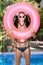 Woman in white sunglasses with pink inner tube