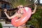 Woman in white sunglasses with pink inner tube