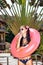 Woman in white sunglasses with pink inner tube