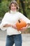 Woman in White Sweater with Pumpkin