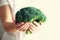 Woman in white T-shirt holding broccoli in hands. Copy space. Healthy clean detox eating concept. Vegetarian, vegan, raw