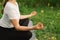 Woman in a white T-shirt and leggings doing yoga in a beautiful field on a sports mat. lifestyle and mindfulness concept