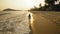 Woman in a white tunic on the beach, near the stormy sea. Blonde