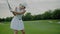 Woman in White Uniform Hits Golf Ball.
