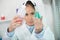 woman in white uniform in laboratory work on analize