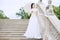 Woman in white Victorian dress with umbrella