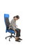 Woman who adjusts her ergonomic chair in the office