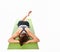 Woman who practices yoga relaxed lying on the mat face down on a white background.