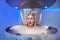 Woman in a whole body cryotherapy cabin