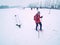 Woman on winter adventure trip on snowshoes in fresh snow