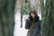 Woman winter clothing drinking coffee snowy forest