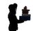 Woman winter coat carrying christmas gifts silhouette