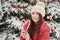 Woman in winter park. Beautiful girl in winter snowy forest. Christmas, holidays and leisure concept - happy young woman outdoors