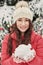 Woman in winter park. Beautiful girl in winter snowy forest. Christmas, holidays and leisure concept - happy young woman outdoors