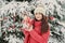 Woman in winter park with gift box. .Beautiful girl in winter snowy forest.  Christmas, holidays and leisure concept - happy young