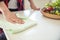 Woman wipes white table with wooden bowl