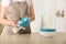 Woman wiping bowl with paper towel in kitchen