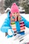 Woman wiping car windshield using brush snow