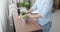 Woman wiping dust from table at home