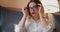 Woman wiping eyeglasses surface with soft cloth, using microfiber fabric