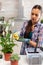 Woman wiping flowers leaves on kitchen