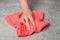 Woman wiping stone surface with kitchen towel