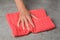 Woman wiping stone surface with kitchen towel