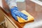 Woman wiping table countertop in kitchen by wet cloth rag. Female charwoman hand cleaning disinfect office home restaurant