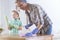 Woman wiping a table and her daughter helping her