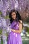 Woman wisteria lilac dress. Thoughtful happy mature woman in pur