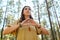 Woman or witch performing magic ritual in forest