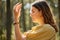 Woman or witch performing magic ritual in forest