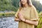 Woman or witch performing magic ritual on river