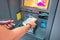 Woman withdraws Armenian drams cash from an ATM. The concept of the exchange rate of currencies and