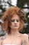 Woman withRed Orange Teased Hair with Dead Flowers