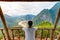 Woman on wooden balcony conquering mountain top at Nong Khiaw Nam Ou River valley Laos mature people traveling millenials concept