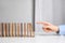 Woman with wooden dominoes at white table, closeup