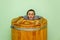 Woman in wooden hot tub, barrel sauna or cedar bathtub