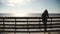 Woman on the wooden stairs in the dunes beach on the sea in hat enjoying life and leisure, everyday successful women